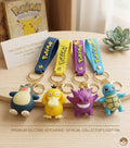 Premium 3D Pokémon character keychains featuring Snorlax, Psyduck, Gengar, and Squirtle with colorful wrist straps and gold-tone hardware